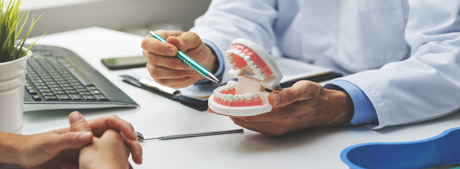 A dental professional examining a patient s teeth with a stethoscope, in a modern office setting.